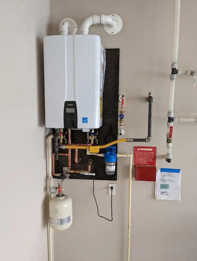 Professional plumber installing copper piping in a Security-Widefield home